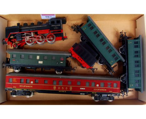 A Fleischmann H0 2-6-0 engine and tender DB black (G) 3 green four wheel coaches and a DSG red bogie 'Schlafwagen' (G)