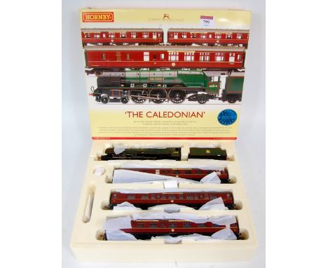 A Hornby R2306 'The Caledonian' train pack containing BR lined green 'King George VI' engine and tender and MK1 maroon compos