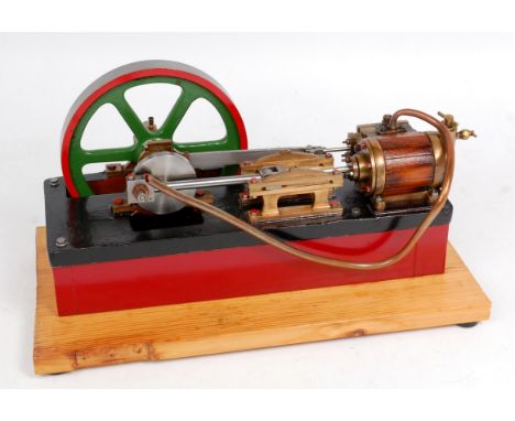 A well engineered live steam stationary horizontal mill engine, comprising of single wooden clad cylinder fitted with slip ec