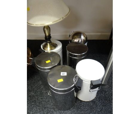 A collection of small pedal bins together with a brass effect table lamp