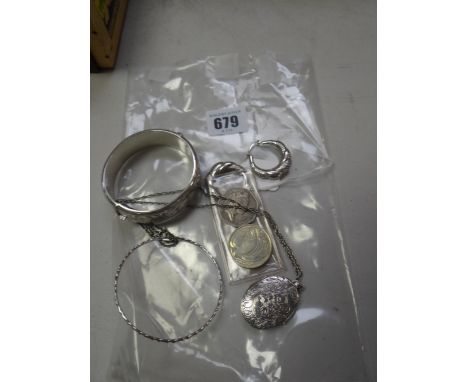 A bright cut silver bangle, silver locket, two coins etc