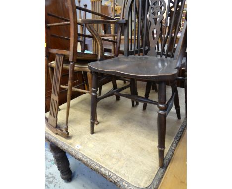 An antique carved dining table & sundry chairs