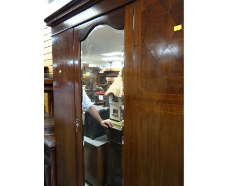 A vintage mirrored wardrobe with base drawer
