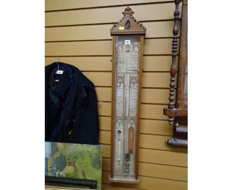 An Admiral Fitzroy barometer in a carved Gothic oak case