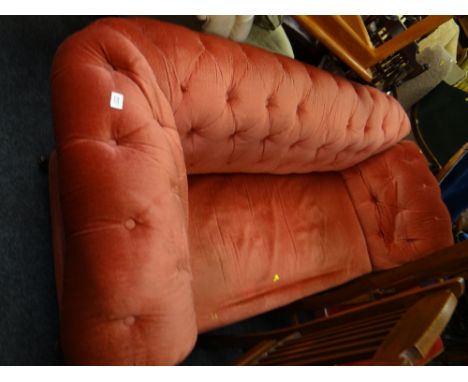 An early twentieth century red velvet button backed drop end sofa