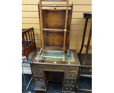 A compact kneehole desk with tooled green leather top together with a jacket suit stand & fire screen / cake stand