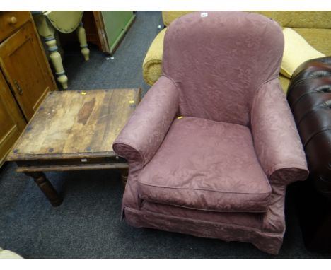 A reproduction loose covered armchair together with a rustic darkwood side table