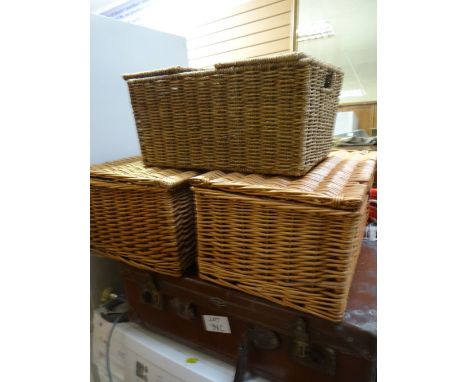 A vintage leather suitcase together with three wicker baskets