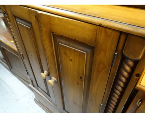 A reproduction entertainment cabinet in pine & Long John coffee table