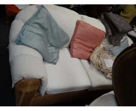 A three-seater rattan rolled arm & back sofa with loose covers