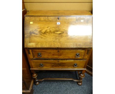 A vintage sloped two-drawer bureau