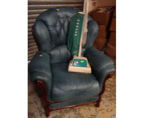A modern blue leather & dark wood framed wingback scroll-top armchair together with a vintage Hoover vacuum cleaner
