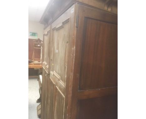 A stripped back two-door vintage pine wardrobe