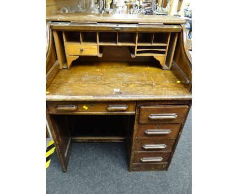 A vintage roll-top kneehole desk (distressed)