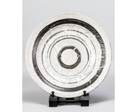 ROBIN WELCH (1936-2019); a large raku dish partially covered in white crackle glaze, impressed mark, made circa 1980, diamete