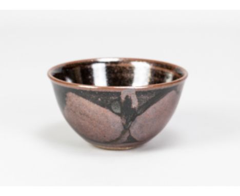 DAVID LLOYD JONES (1928-1994); a small stoneware bowl covered in iron rich glaze with wax resist decoration, impressed LJ mar