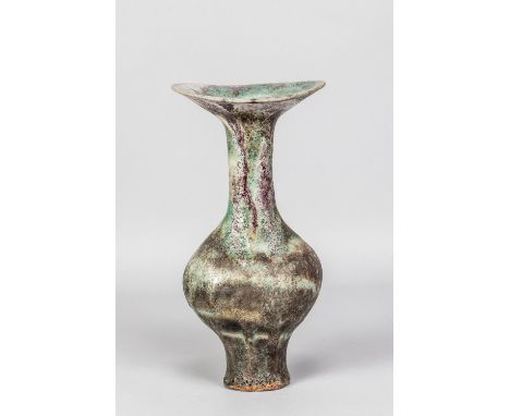 LUCIE RIE (1902-1995); a tall stoneware bottle with flared undulating rim and oval neck covered in eruptive and pitted copper