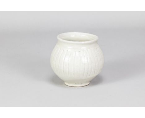 BERNARD LEACH (1887-1979) for Leach Pottery; a fluted porcelain pot covered in celadon glaze, impressed BL and pottery marks,