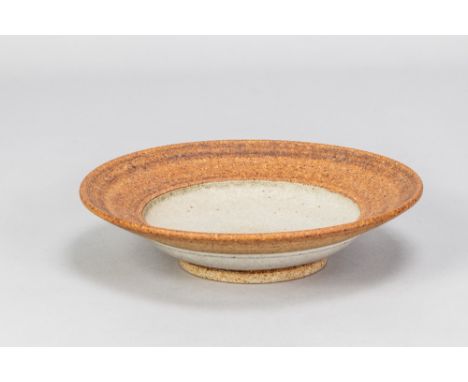 ROBIN WELCH (1936-2019); a stoneware footed bowl with mottled iron wash to rim, impressed mark, made 1970s, diameter 22.5cm. 