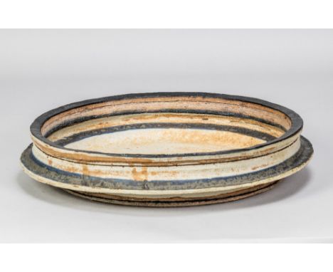 ROBIN WELCH (1936-2019); a large stoneware flanged dish with banded decoration, painted signature, made 1960s, diameter 34cm.