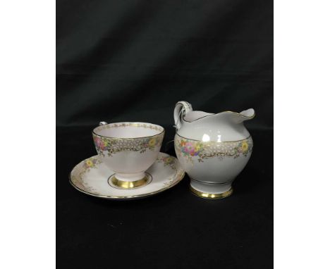 TUSCAN TEA SERVICEdecorated with flowers in colours and gilt, comprising twelve cups, twelve saucers and twelve side plates, 