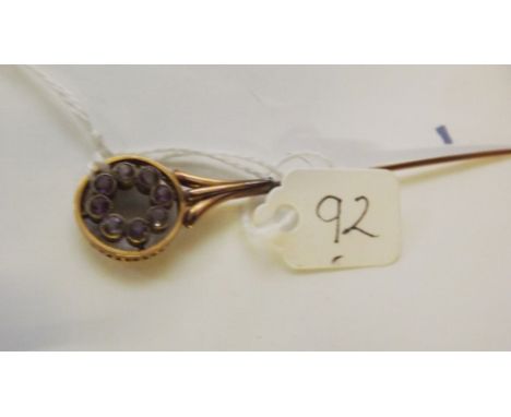 An antique 9ct amethyst set stick pin     