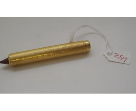 An 18ct gold engine turned pencil holder 21g inc   