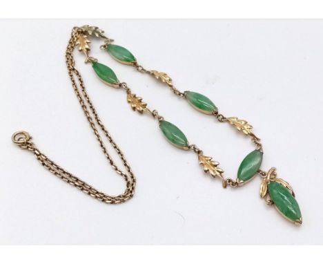 A 14K yellow Gold Jade Oval Cabochon Necklace. A belcher link necklace decorated with five jade cabochons and finished with a