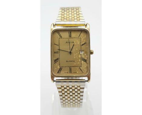 A Vintage Avia 9K Gold Cased Watch. Gilded strap. Gold rectangular case - 33 x 23mm. Dial is worn on one side. In working ord