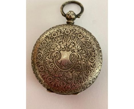 Antique Ladies SILVER pocket watch, having white enamel face with floral detail and black Roman numerals. Silver case intrica