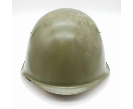A 1980s Soviet Army Hard Steel Helmet. Leather strap and inner. 