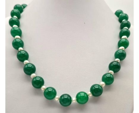 A Jade and Seed Pearl Necklace. 10mm jade beads, 