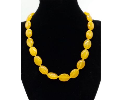 A Yellow Jade Flat Bead Necklace. 15mm. 42cm. 