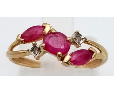 A 9K Yellow Gold Ruby and Diamond Crossover Ring. Size L. 1.3g total weight. 