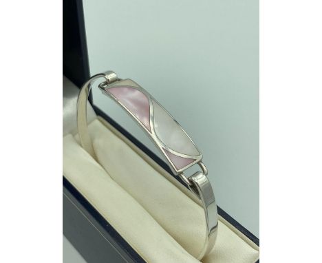 SILVER BANGLE with two tone mother of pearl  rectangular tablet mounted to top. Complete with jewellers quality bangle gift b