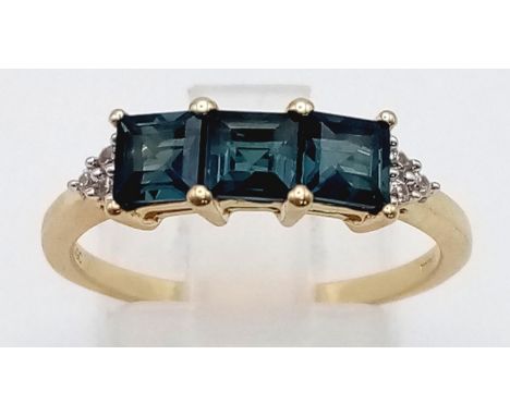 A 10K Yellow Gold Blue Tourmaline and Diamond Ring. Three square cut tourmalines with diamonds either side. Size P. 2.22g tot