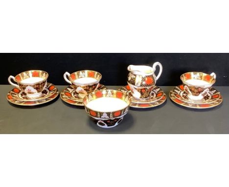 An Abbeydale Crysantheyum pattern part tea service comprising three tea cups, four saucers, four side plates, cream jug and a