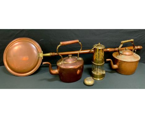A 19th centuty copper kettle; another; an Eccles miner's lamp; copper warming pan 
