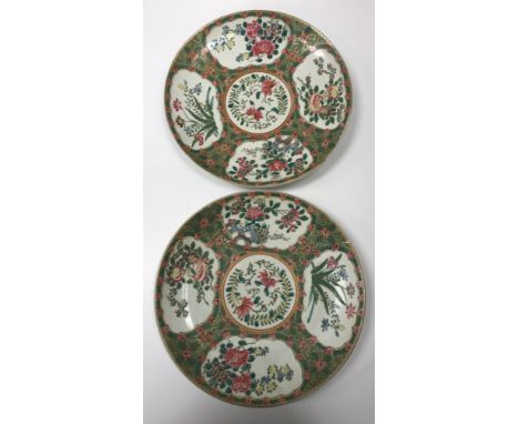 A pair of Chinese famille rose chargers decorated with panels of flowers bearing blue under glazed six character mark and imp