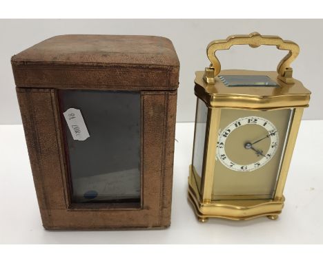 An early 20th Century gilt brass cased carriage clock, the movement with silvered chapter ring and Arabic numerals within a s