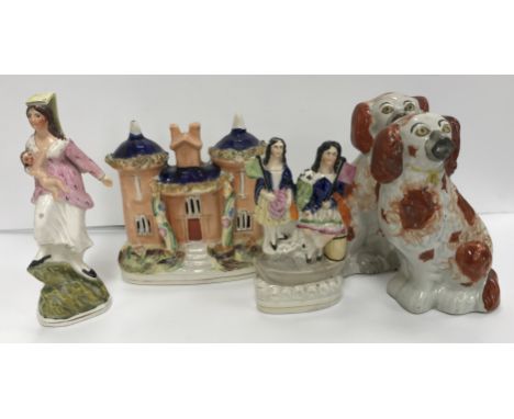 A collection of Staffordshire Pottery including two spaniel figures, 18 cm high, cottage 17 cm high, two girls with flags in 