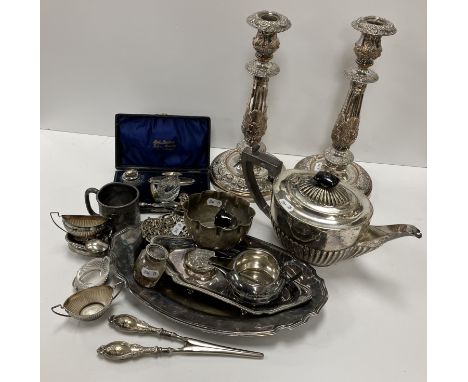 A pair of 19th Century plated on copper table candlesticks in the Rococo manner, with all-over scrolling foliate and floral d