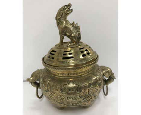 A Chinese bronze censer with pierced cover, the cover with Dog of Fo finial and script decoration, the main body decorated wi