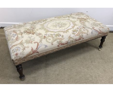 A late Victorian rectangular drawing room stool with aubusson style tapestry upholstered seat on carved and turned tapering o