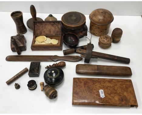 A collection of small treenware items to include a circular lignum vitae six place coaster set, bodkin case, needle case, bar