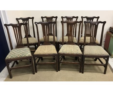 A set of eight 19th Century oak Provincial Chippendale style dining chairs with drop-in needlework seats on square chamfered 