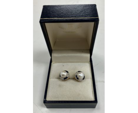 A pair of 18 carat gold mounted pearl, sapphire and diamond ear studs, the central pearl approx size 8, within a band of alte