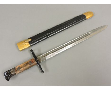 An Italian Carcano model 1891 knife bayonet, in dated leather scabbard, stamped ARET 1933, with metal mounts, blade 29.7cm