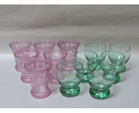Two sets of six coloured glass tumblers, to include a set of late 19th century amethyst flash etched glasses