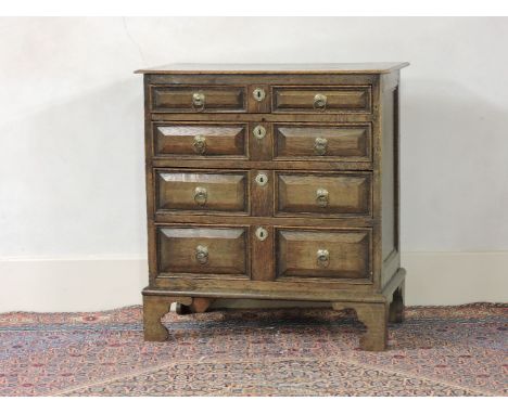 A 17th century oak chest of drawers, having four long drawers with moulded fronts, on later bracket feet, 91cm wide, with dam